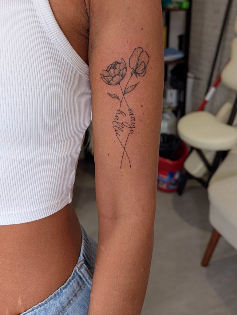 IMG_20250725_170651_038 Minimalist wild flower bouquet arm tattoo by Leanne at Kimmer Ink Tattoo Studio in Eastleigh, Hampshire.