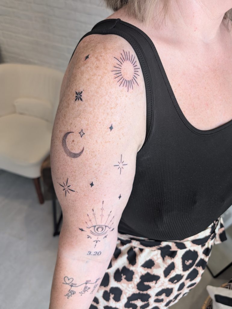 PXL_20250711_120028781.MP Celestial sun, moon, and stars shoulder tattoo by Leanne at Kimmer Ink Tattoo Studio in Eastleigh, Hampshire.