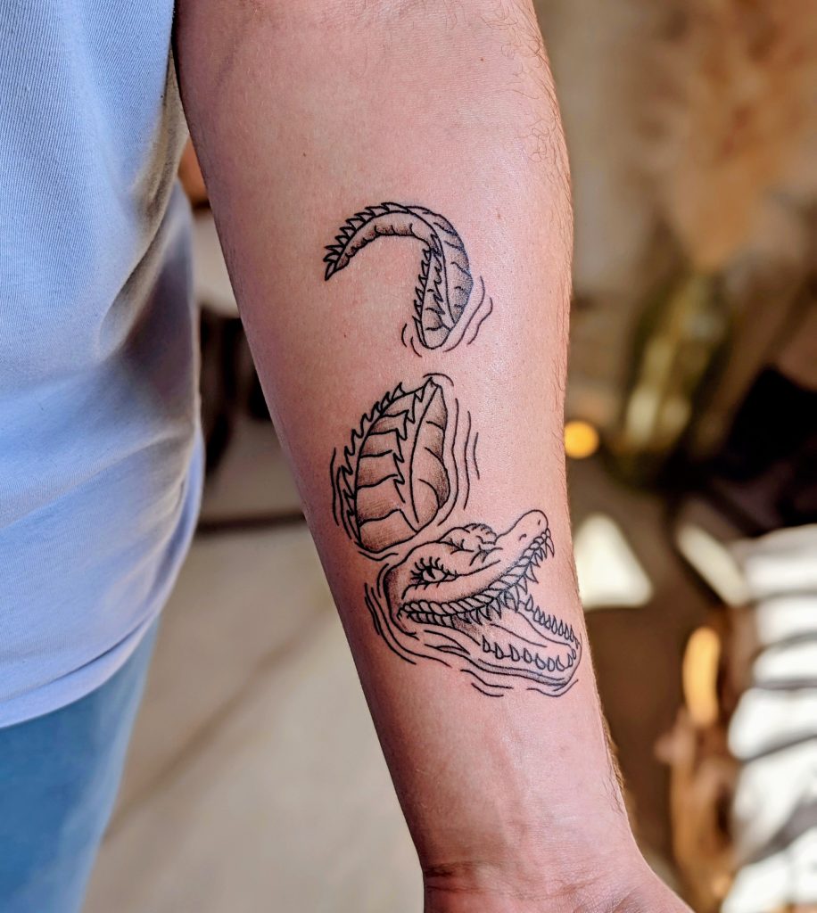 d6bdc839-8109-439f-92b5-a58b441bbd45~1 Fine line feather and scroll arm tattoo by Leanne at Kimmer Ink Tattoo Studio in Eastleigh, Hampshire.